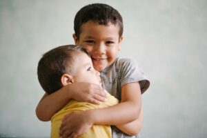 Kid hugging his younger brother