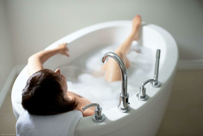 Top view of a serene mature woman in bathtub Top view of a serene mature woman in bathtub