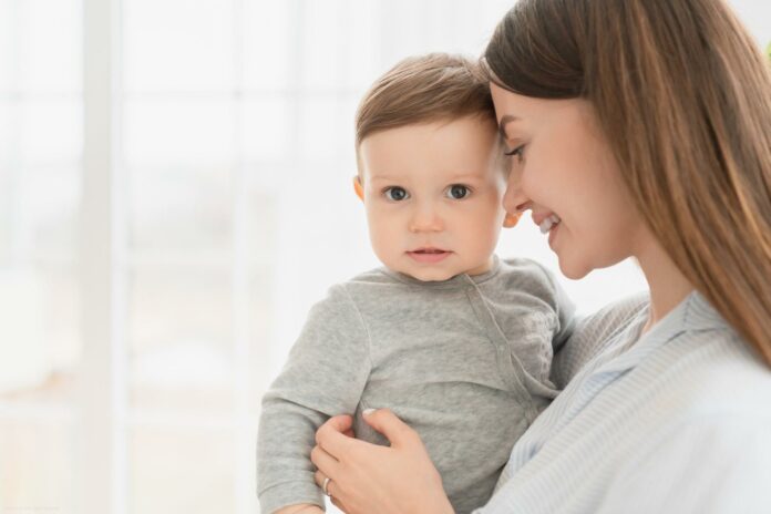 Happy family moments with mother mom. Single young mother holding embracing hugging Happy family moments with mother mom. Single young mother holding embracing hugging