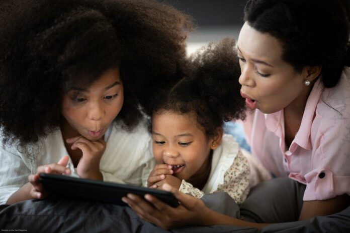 Mother and child are enjoying watching movies on tablet, African people Mother and child are enjoying watching movies on tablet, African people