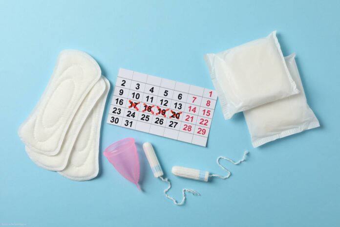 Menstruation period accessories on blue background, top view Menstruation period accessories on blue background, top view