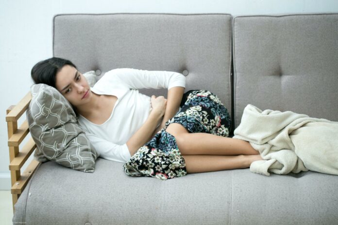 Woman stomach pain. Indoor shot. Woman stomach pain. Indoor shot.