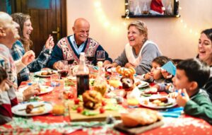 Multi generation family having fun at Christmas dinner event