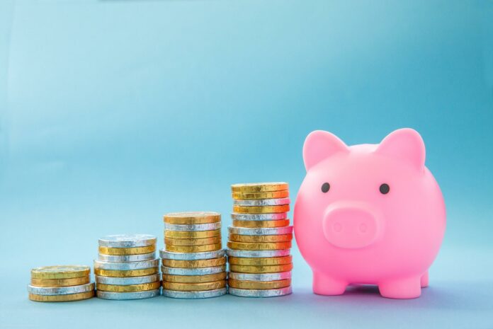 A Home finance or children savings scheme concept showing upwards financial growth with coins A Home finance or children savings scheme concept showing upwards financial growth with coins