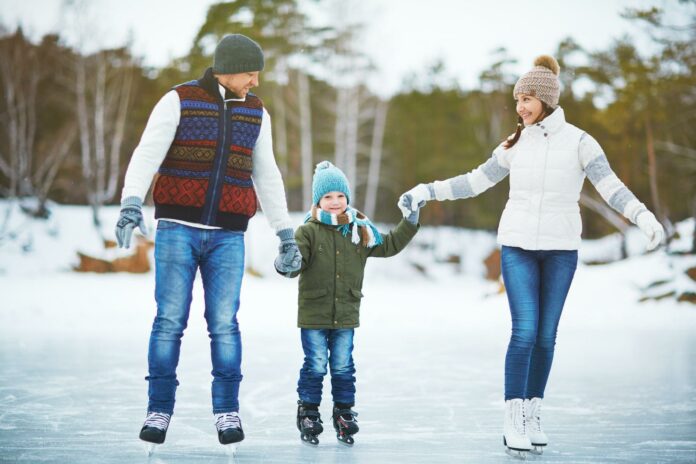 Family in outdoor rink Family in outdoor rink