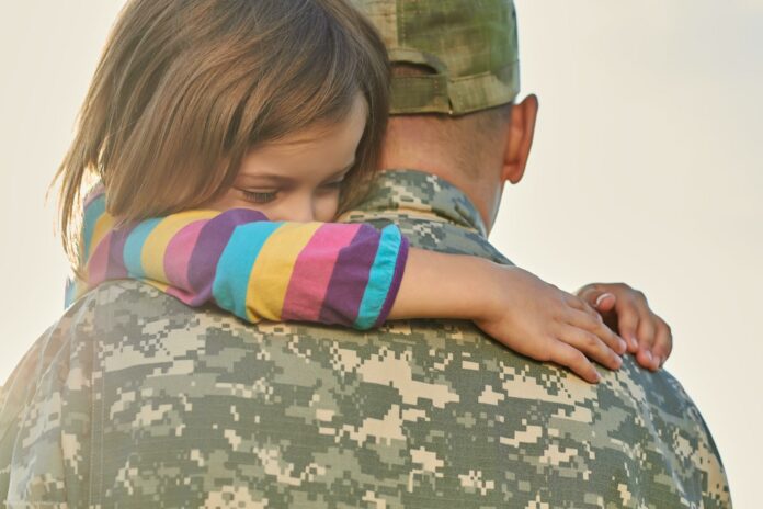Little female child is hugging a soldier. Little female child is hugging a soldier.